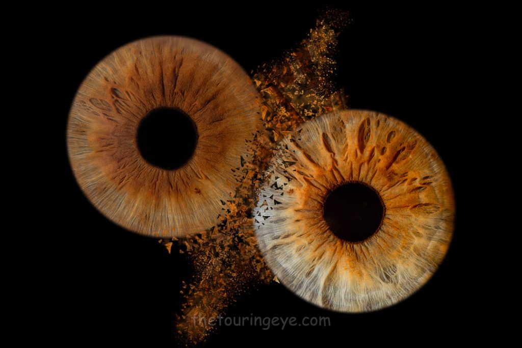 Two eye irises clash in a dramatic way with pieces of the irises scattering from the impact. Eye photography. Iris photography