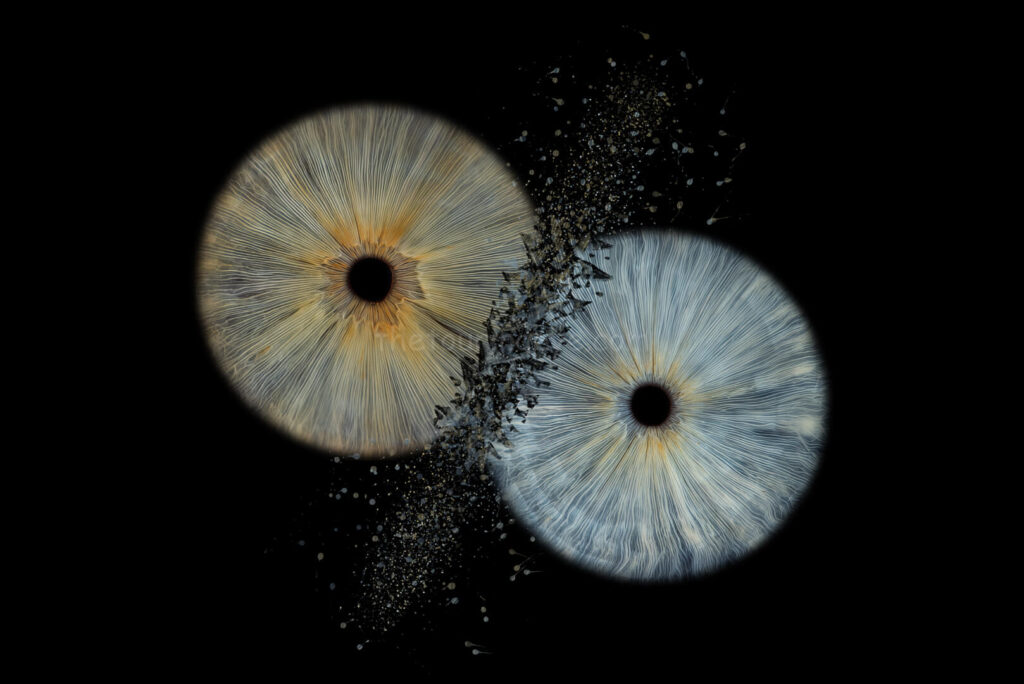 2 blue eye irises clash with particles scattering. Iris photography. Eye photography. The Touring Eye. Eye art. Eye artwork